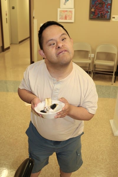 Person with Down syndrome holding a healthy snack