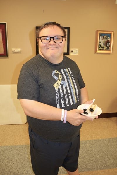 Person with Down syndrome holding a healthy snack