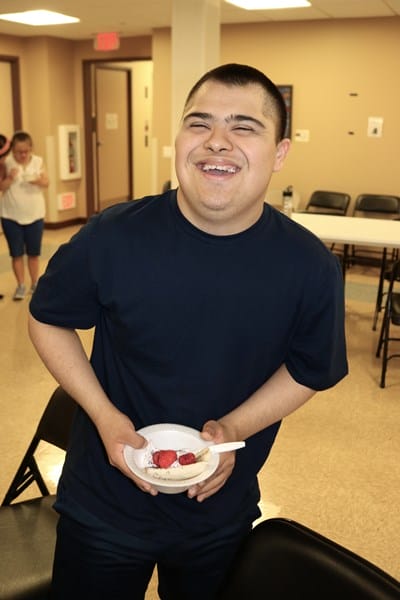Person with Down syndrome holding a healthy snack