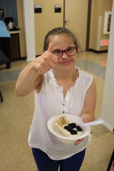 Person with Down syndrome holding a healthy snack