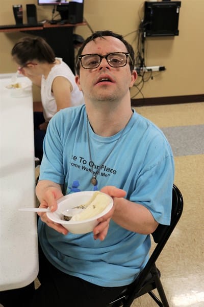 Person with Down syndrome holding a healthy snack