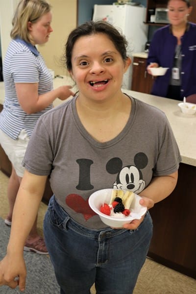 Person with Down syndrome holding a healthy snack